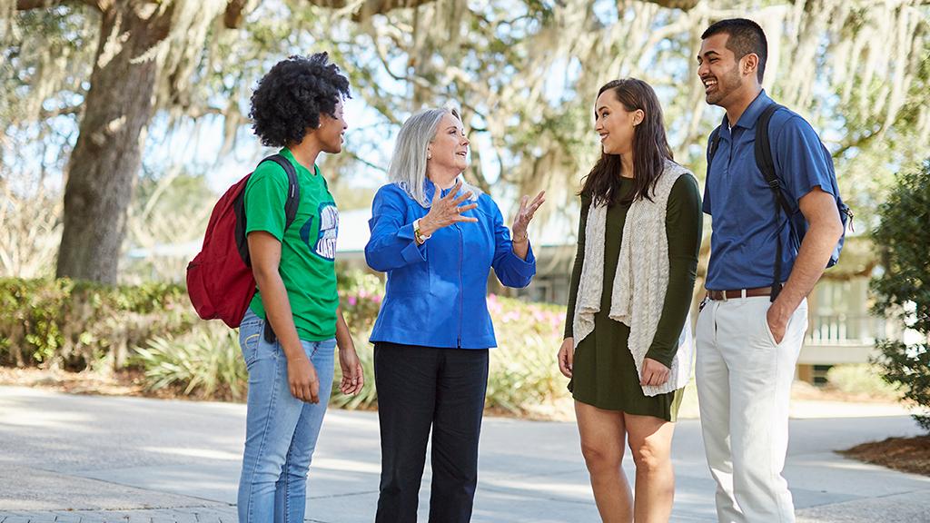 Medium version of the image of UWF's 6th President, Dr. Martha Saunders, talking with people on campus in Pensacola